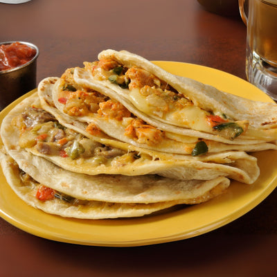 Plate of pork chile verde tacos with onion and cilantro